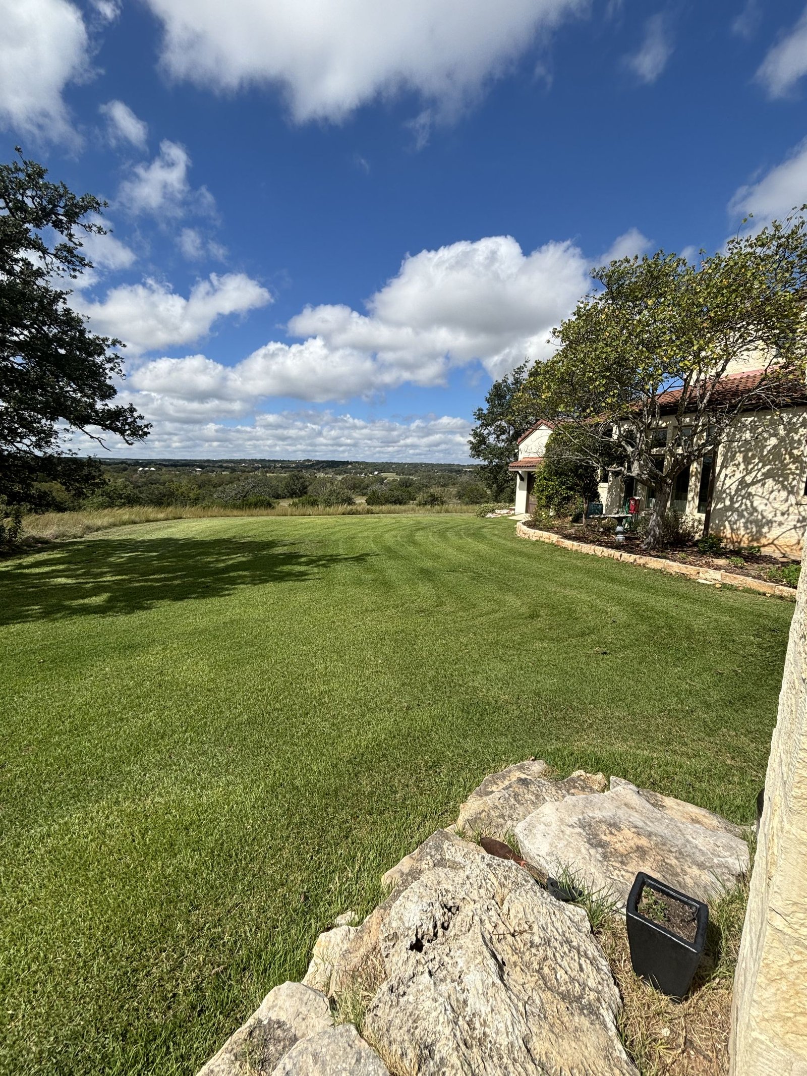 Sloped Hill Country lawn with fresh mow stripes overlooking the hills near Fredericksburg, Texas